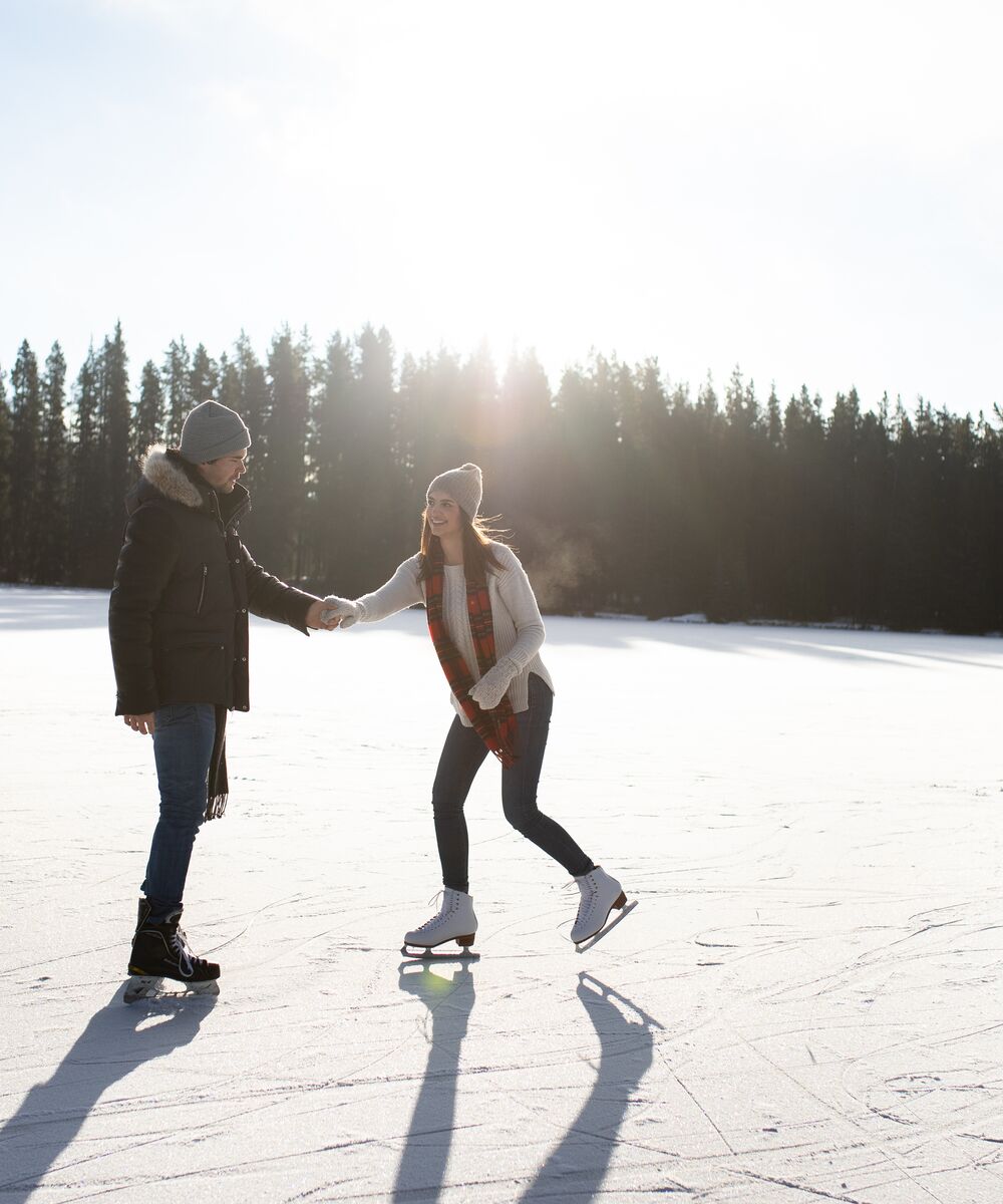 Couple skating on a frozen lake